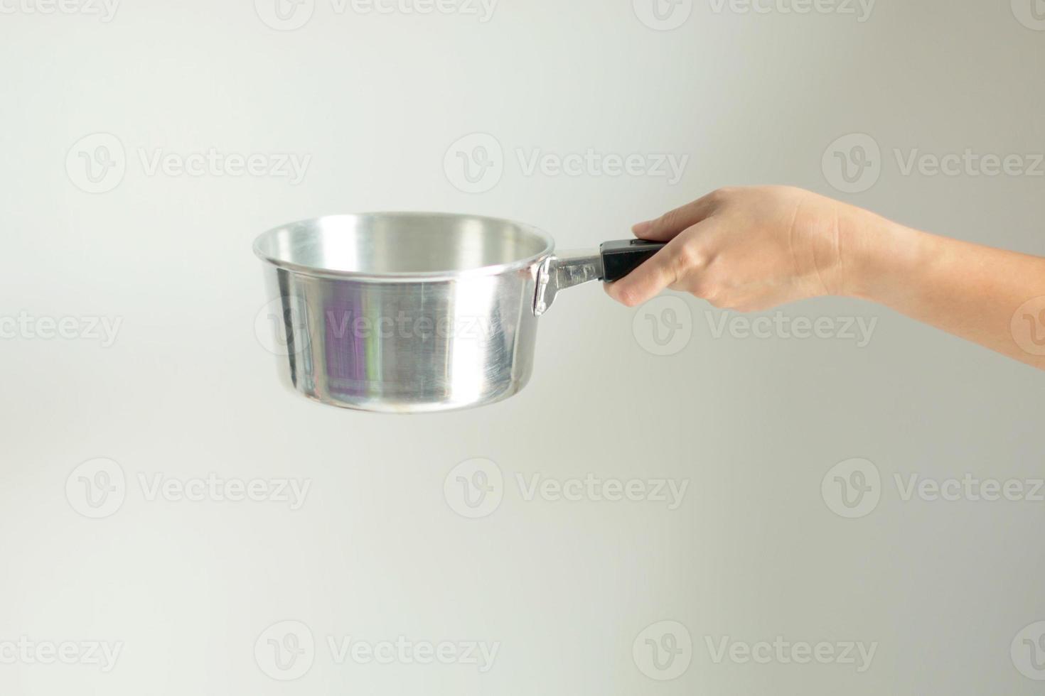 Hand hold pot with handle ready for cooking. photo