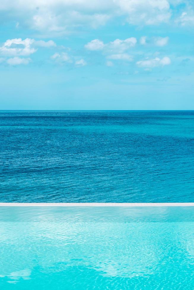 infinity pool at luxury hotel against ocean front, tropical resort. Relaxing, summer,  travel, holiday, vacation and weekend concept photo