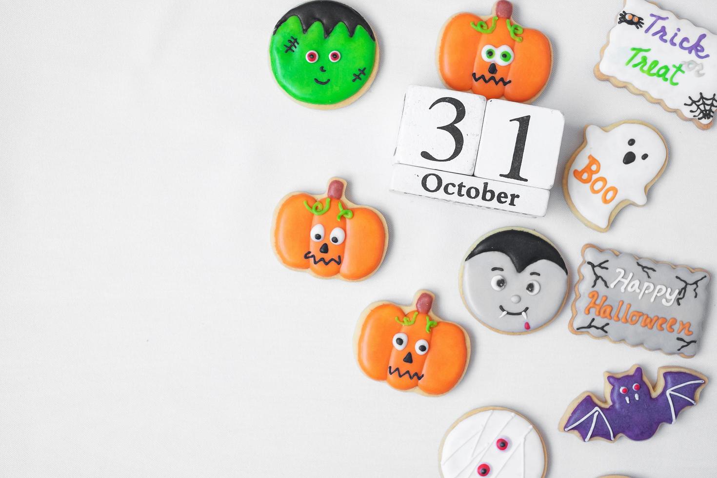Halloween funny Cookies with 31 October calendar on white background. Trick or Threat, Happy Halloween, Hello October, fall autumn, Festive, party and holiday concept photo