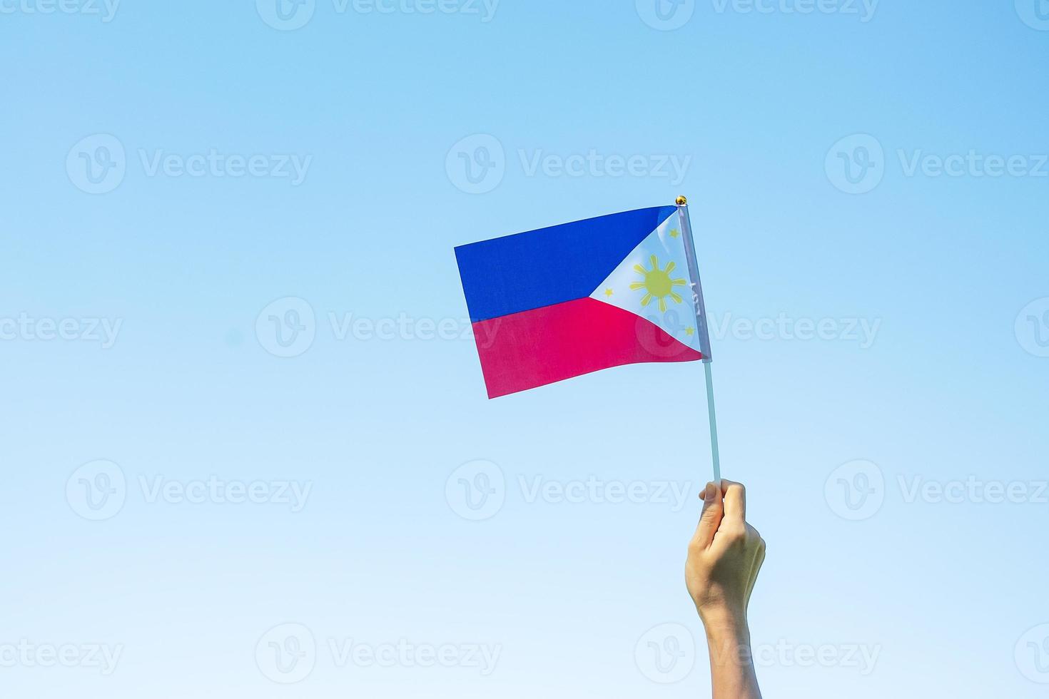 hand holding Philippines flag on nature background. 12th June of Independence day and happy celebration concepts photo