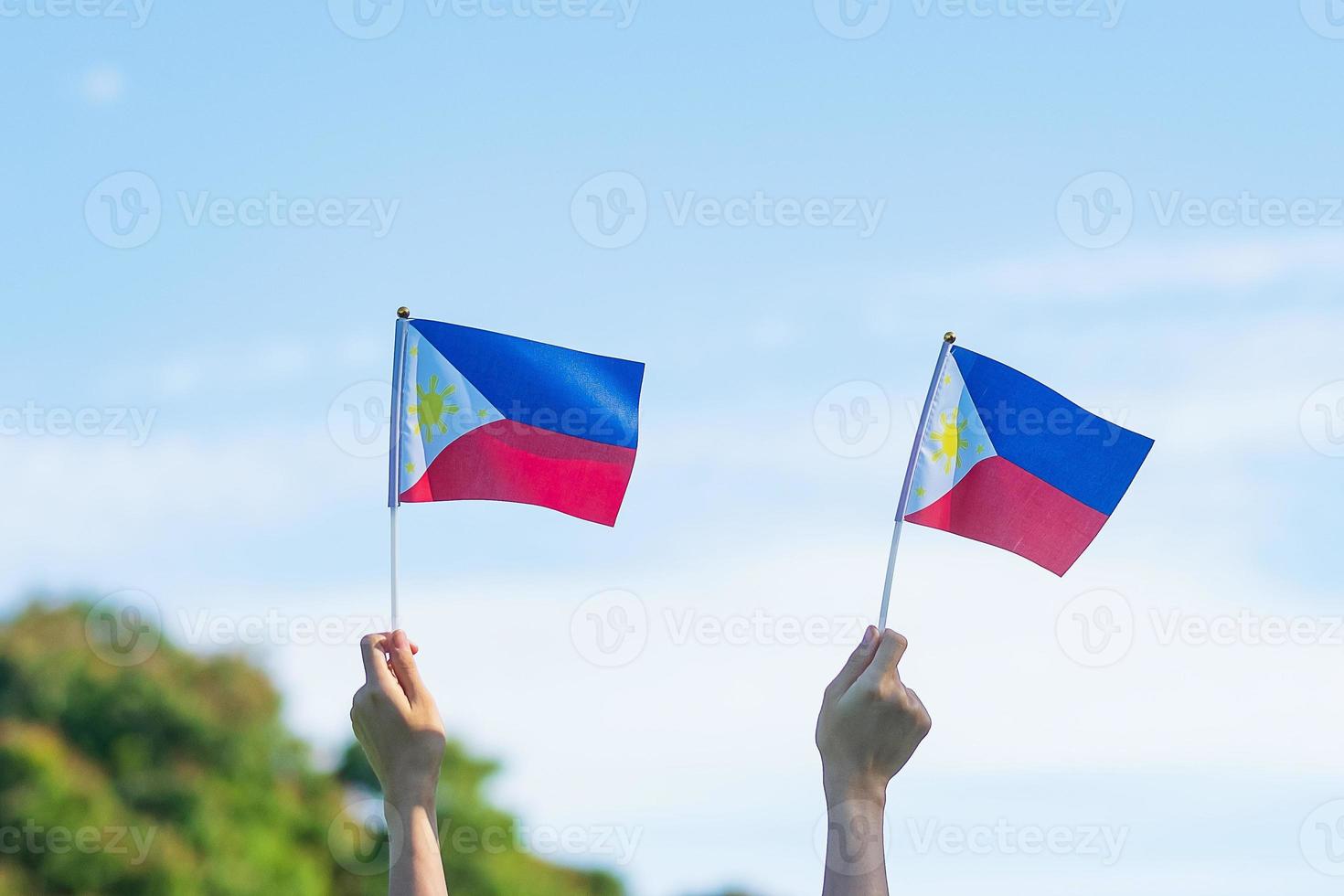 hand holding Philippines flag on nature background. 12th June of Independence day and happy celebration concepts photo