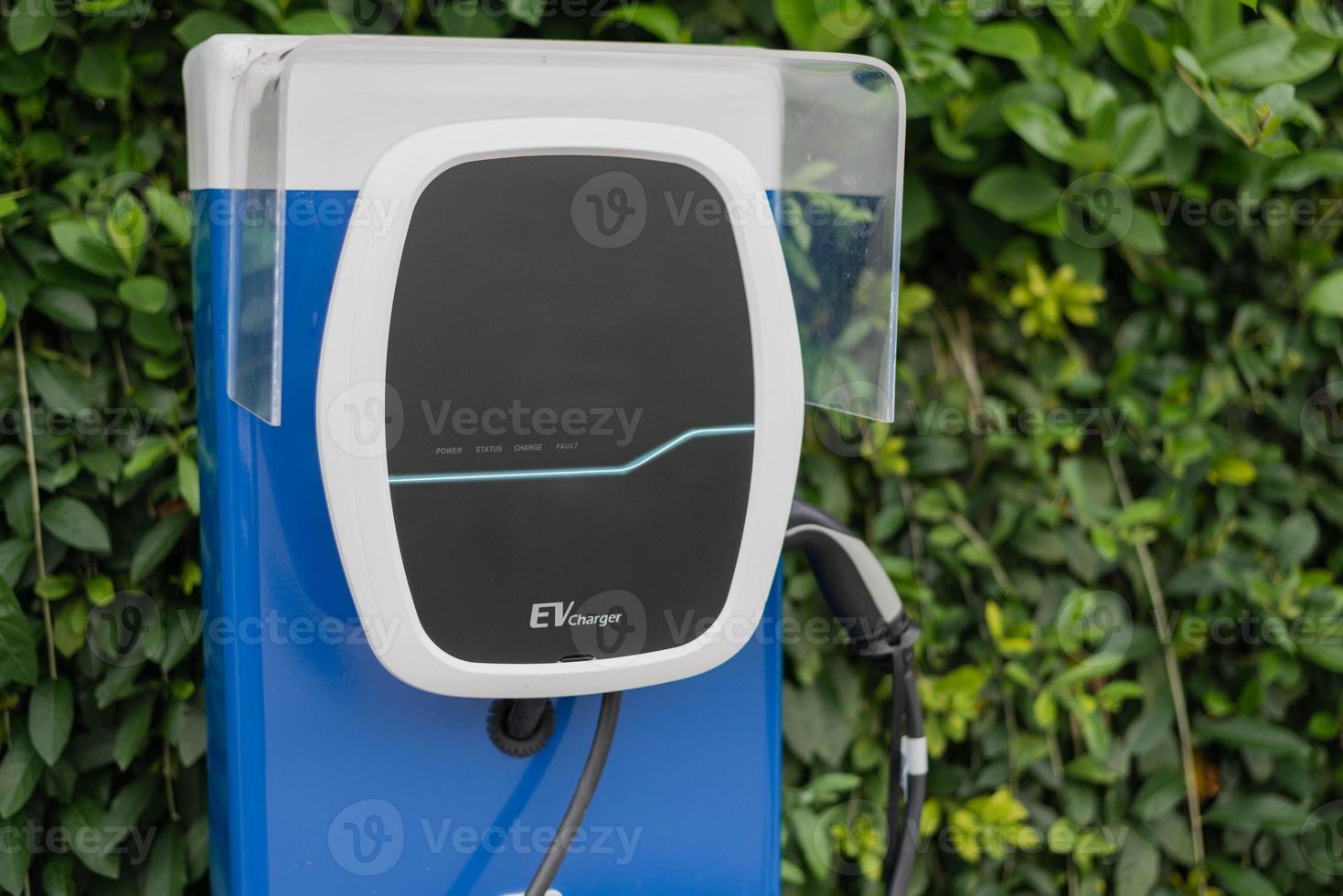 Electric car charging station for charge EV battery in car parking. Green power and future transport technology concept. photo