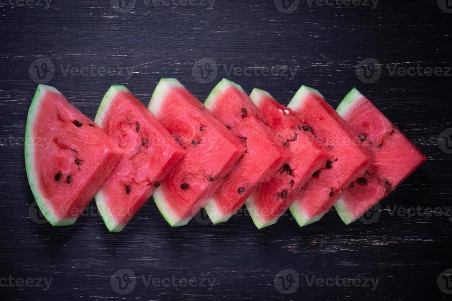 Pieces of refreshing watermelon on a dark wood background. Close-up photo. High quality photo