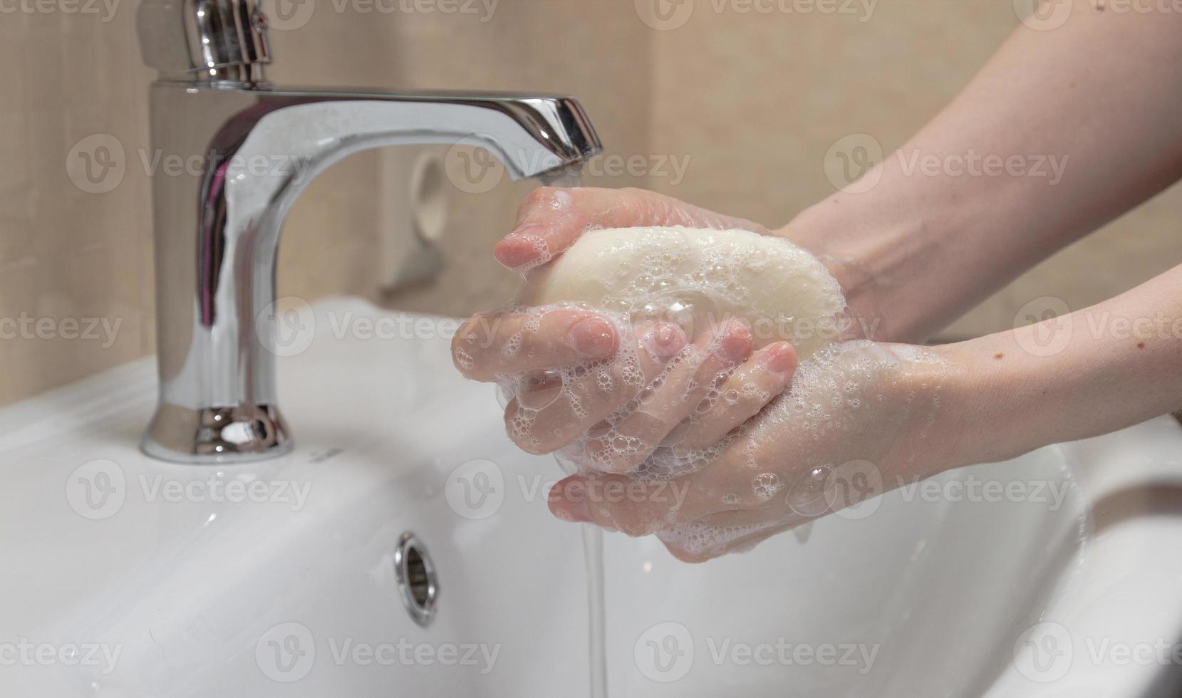Hygiene. Cleaning Hands. Washing hands with soap. Woman's hand with foam. Protect yourself from coronavirus COVID-19 pandemia photo