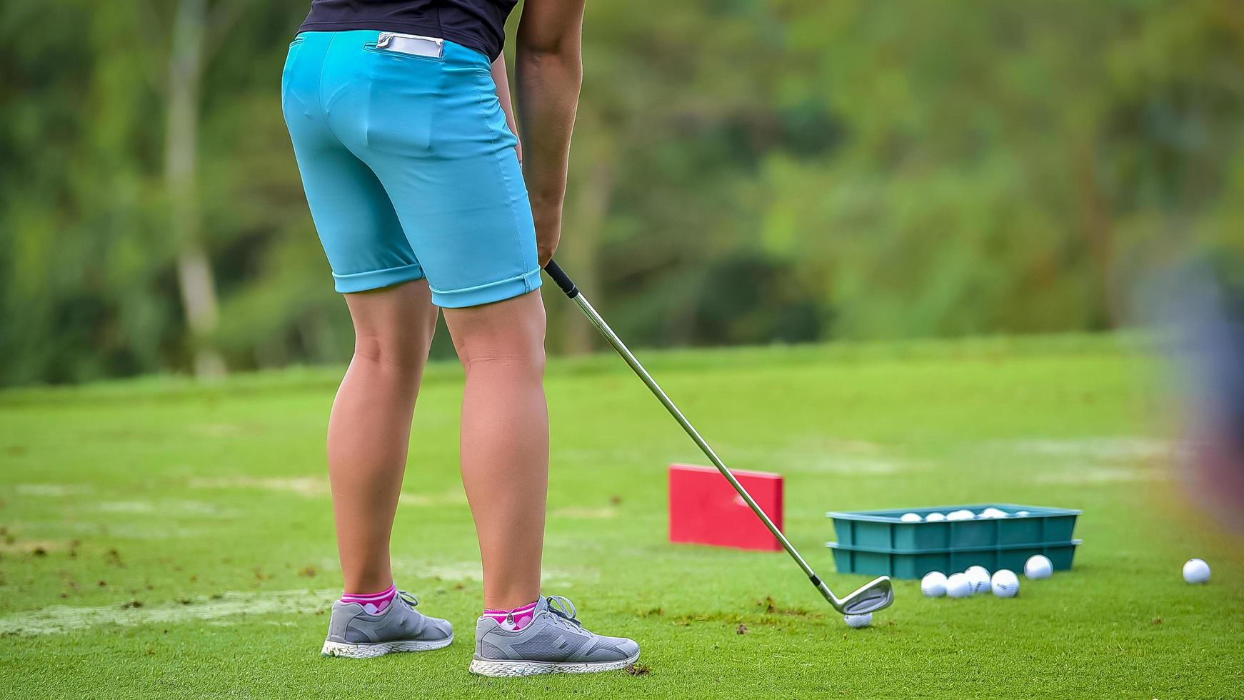 Golfer pushing white golf ball to hole at golf course in golf competition game , sunlight rays and blur background photo