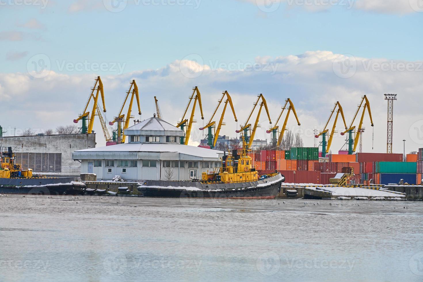 Moored ships and harbor cranes in port photo