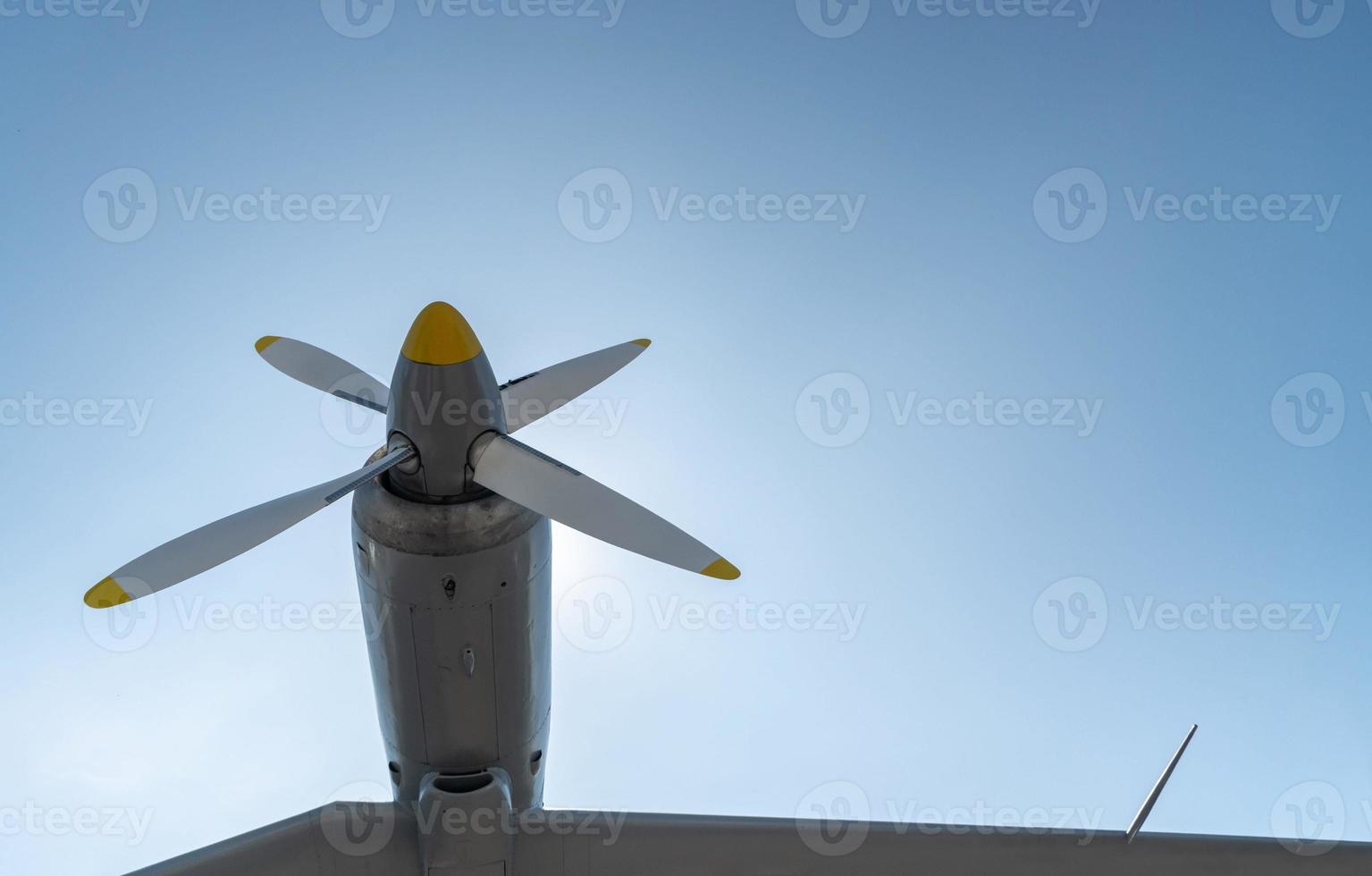 Airplane propeller of military aircraft, copy space. Blue sky sunny background. photo