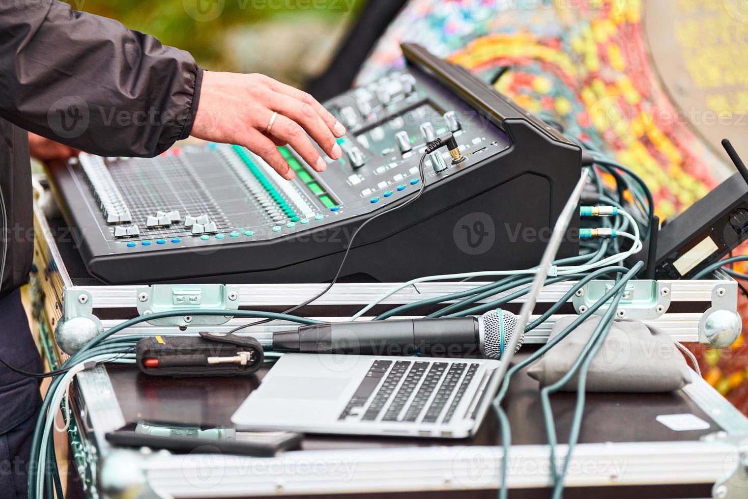 Sound engineer hands working on sound mixer at live concert, stage sound mixer, audio mix slider photo