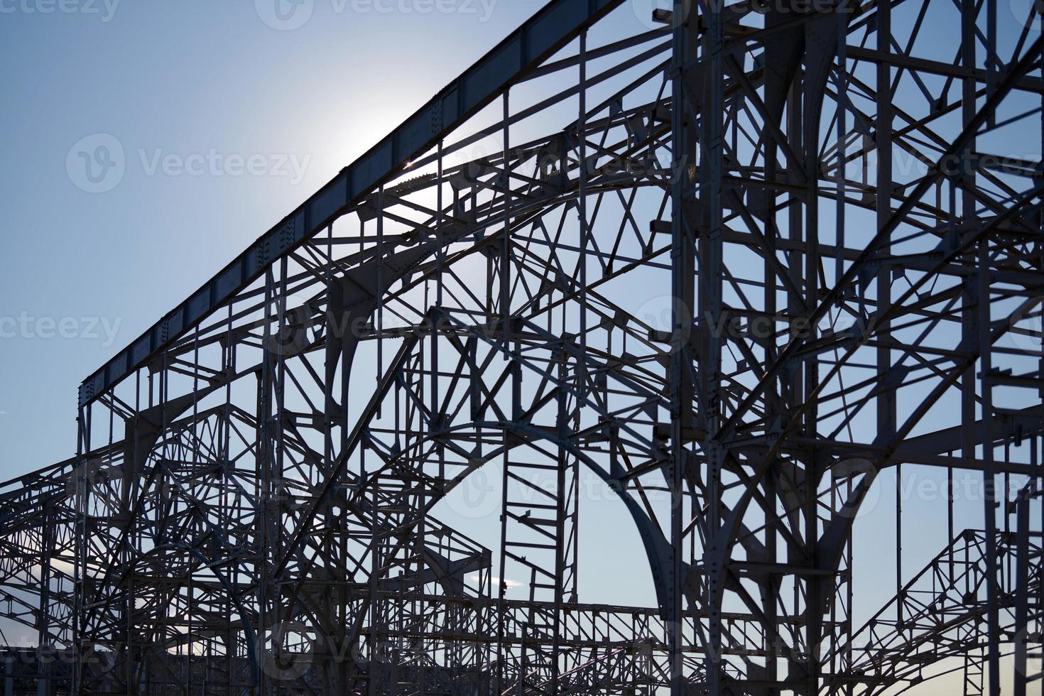 Frame of goods shed. Metal construction of railway building. Old abandoned steel warehouse for goods. photo