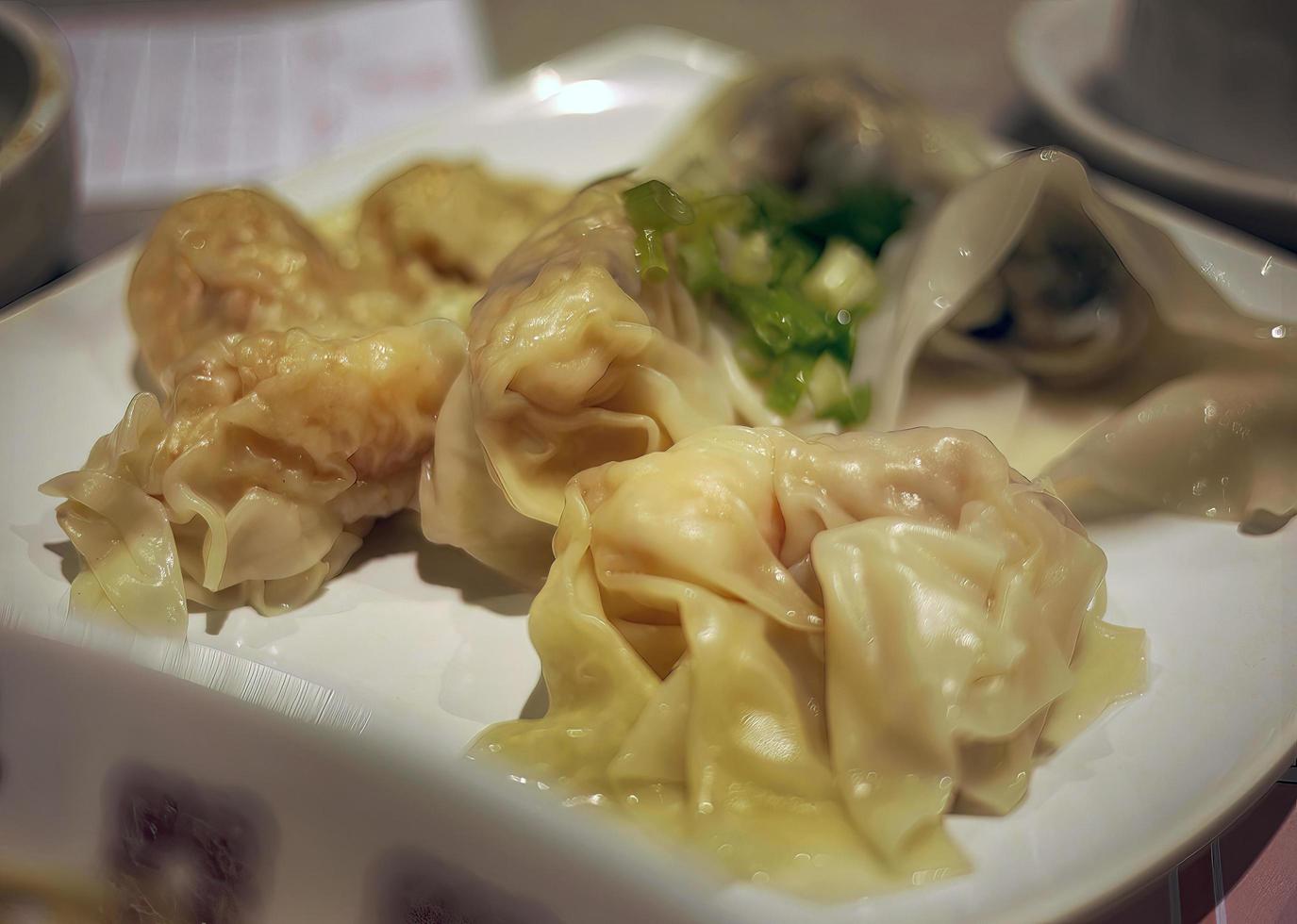 close-up of boiled shrimp wonton on white plate hong kong dim sum photo