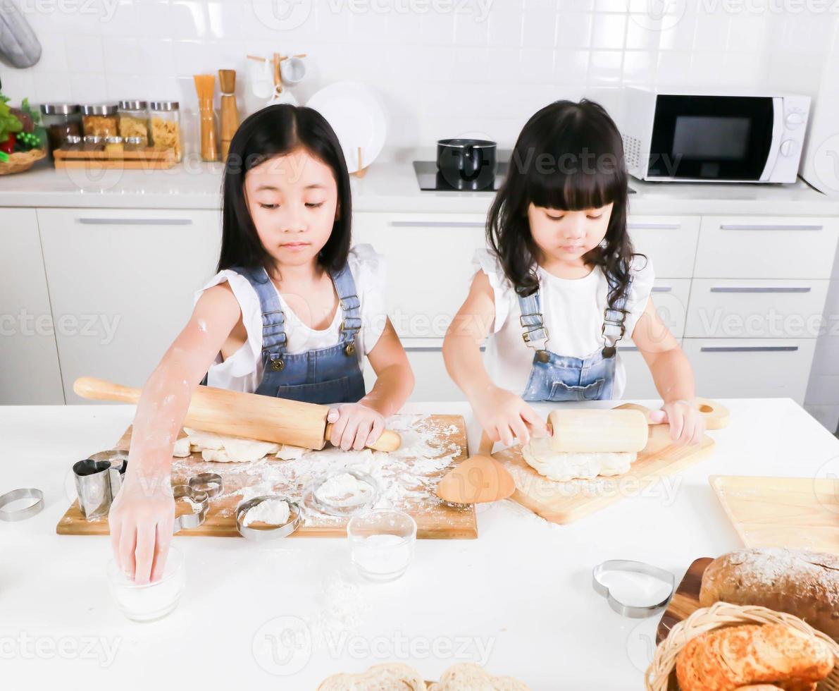 Cute happy little two child have fun baking in the kitchen photo