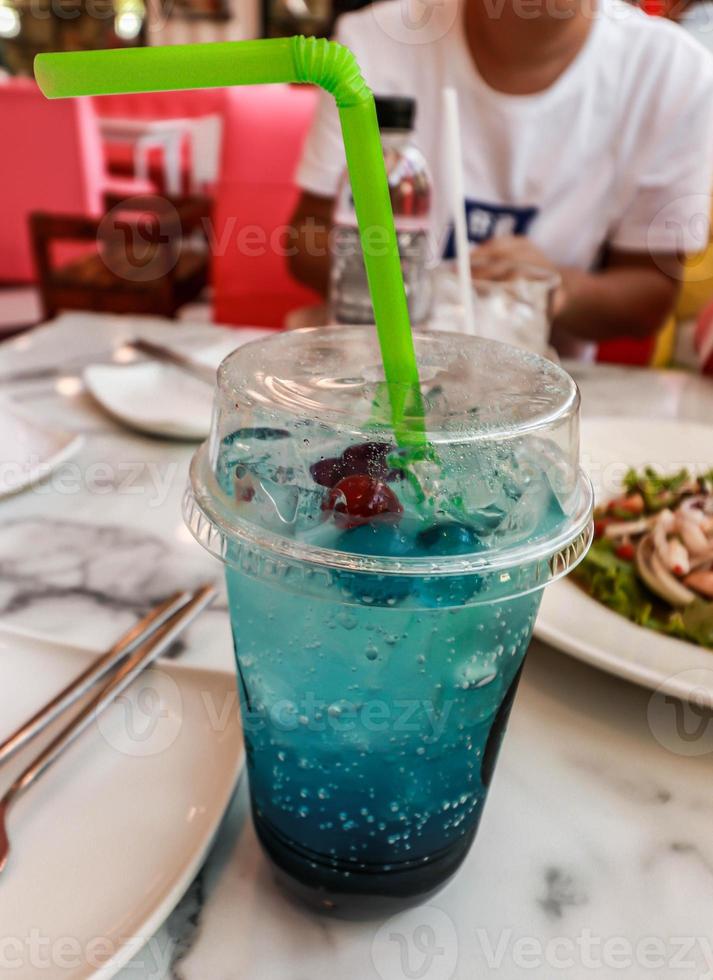 Close up Cup with blue hawaii soda cocktail on the table photo