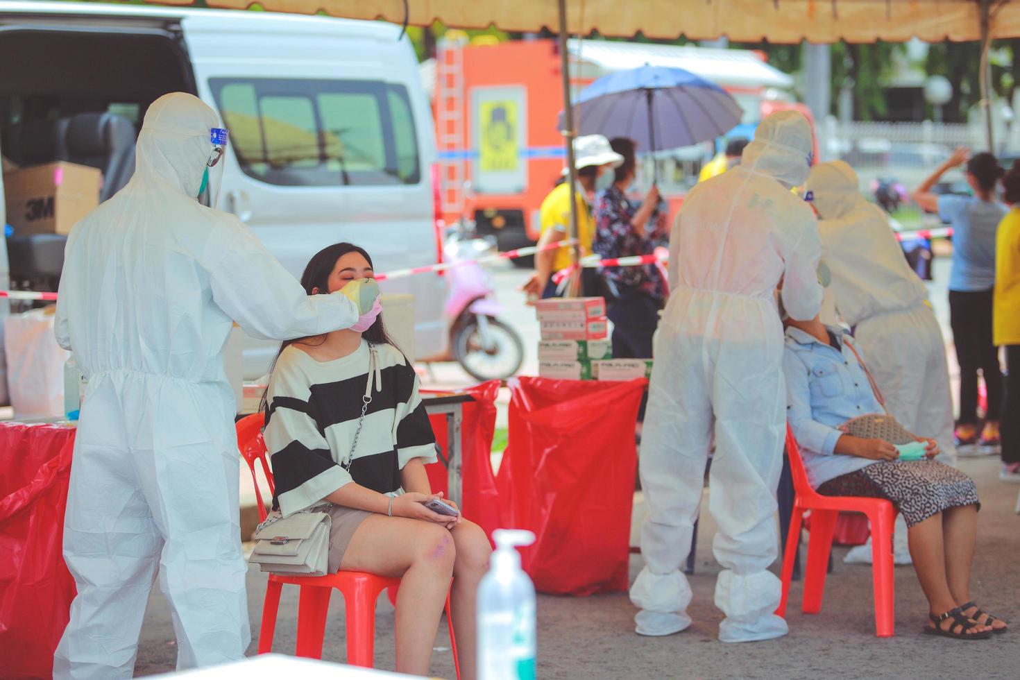 Nakhon Ratchasima, Thailand - 24 April 2021  Public Health Technical Officers collecting secretions  persons for proactive screening COVID19. photo