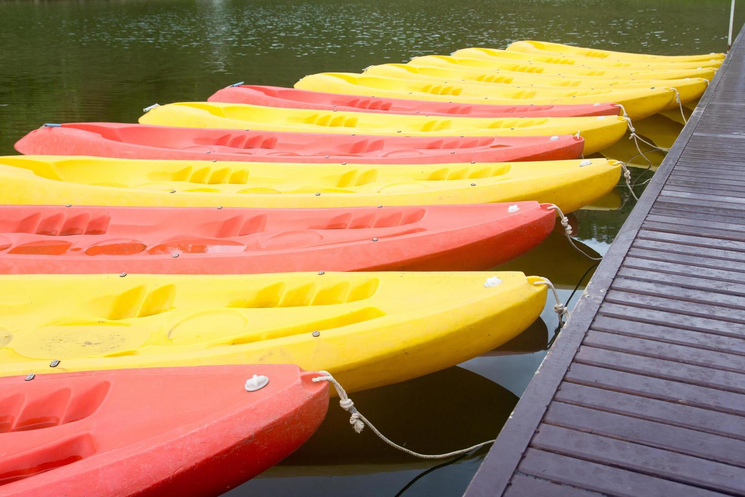 Group of red, yellow color Kayak stop at the port photo