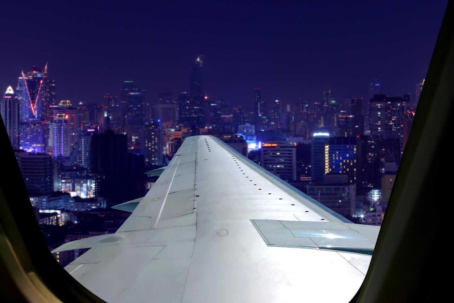 Evening flight on twilight sky, amazing view from the window plane. Window seat on airplane overlooking  city at night view . photo