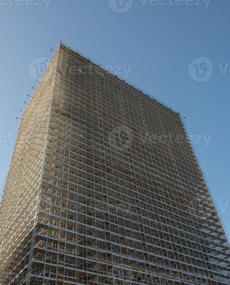 Building with scaffolding and protective sheets photo