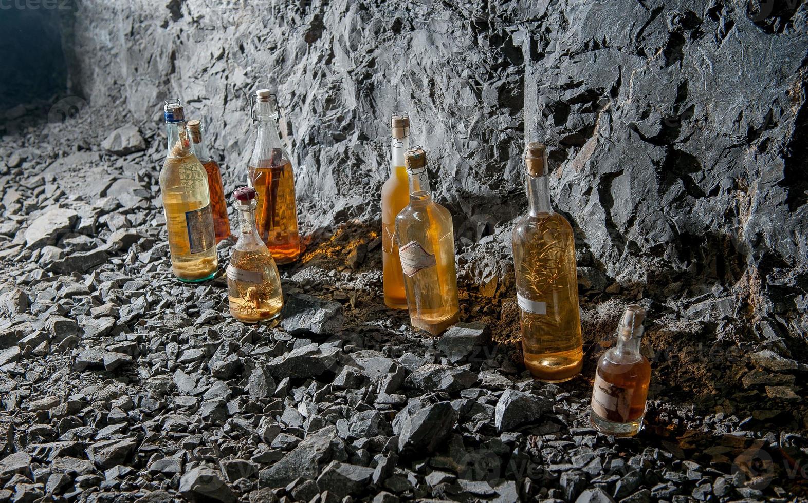 Liquor bottles aged in the mine photo