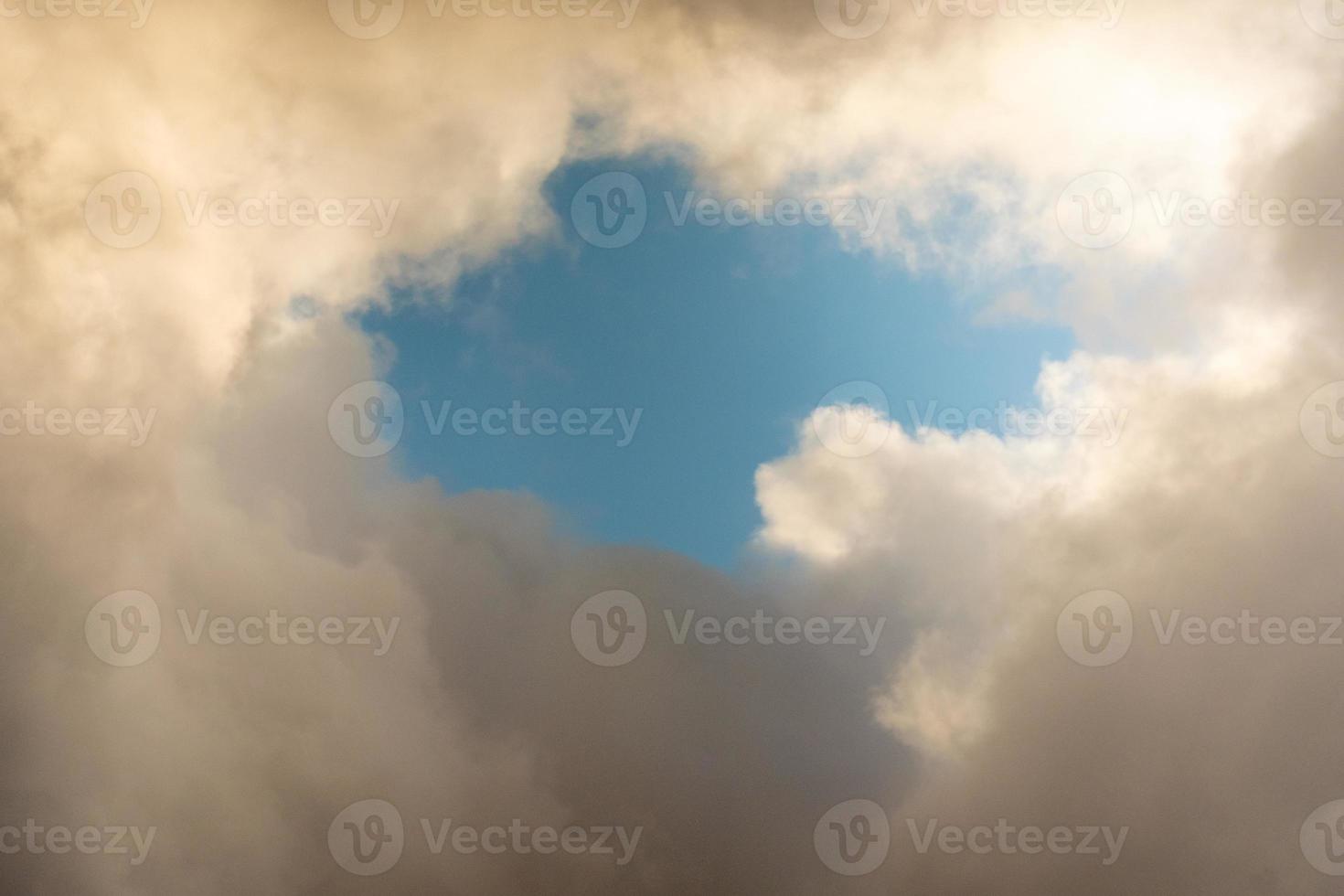 Blue sky behind dark storm clouds background texture, thunderstorm photo