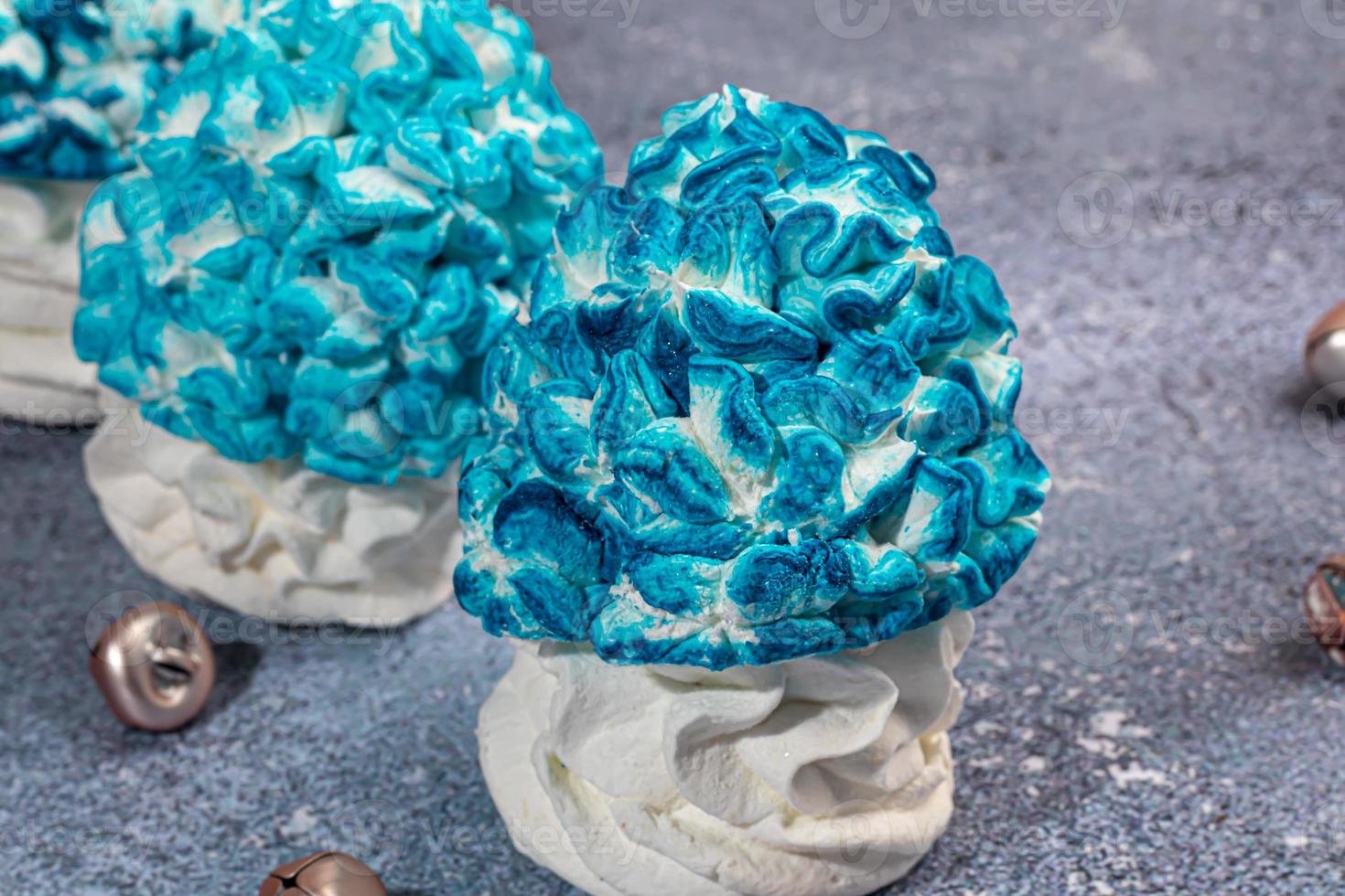 Handmade marshmallows on a light background in the form of roses, hydrangeas and tulips. There are flowers nearby. Women's day, Valentine's day. photo