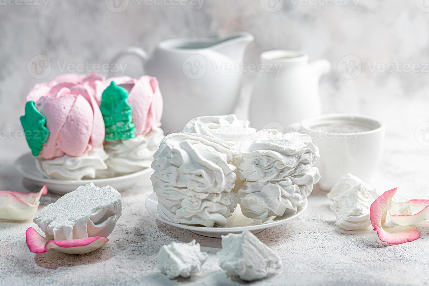 Handmade marshmallows on a light background in the form of roses, hydrangeas and tulips. There are flowers nearby. Women's day, Valentine's day. photo