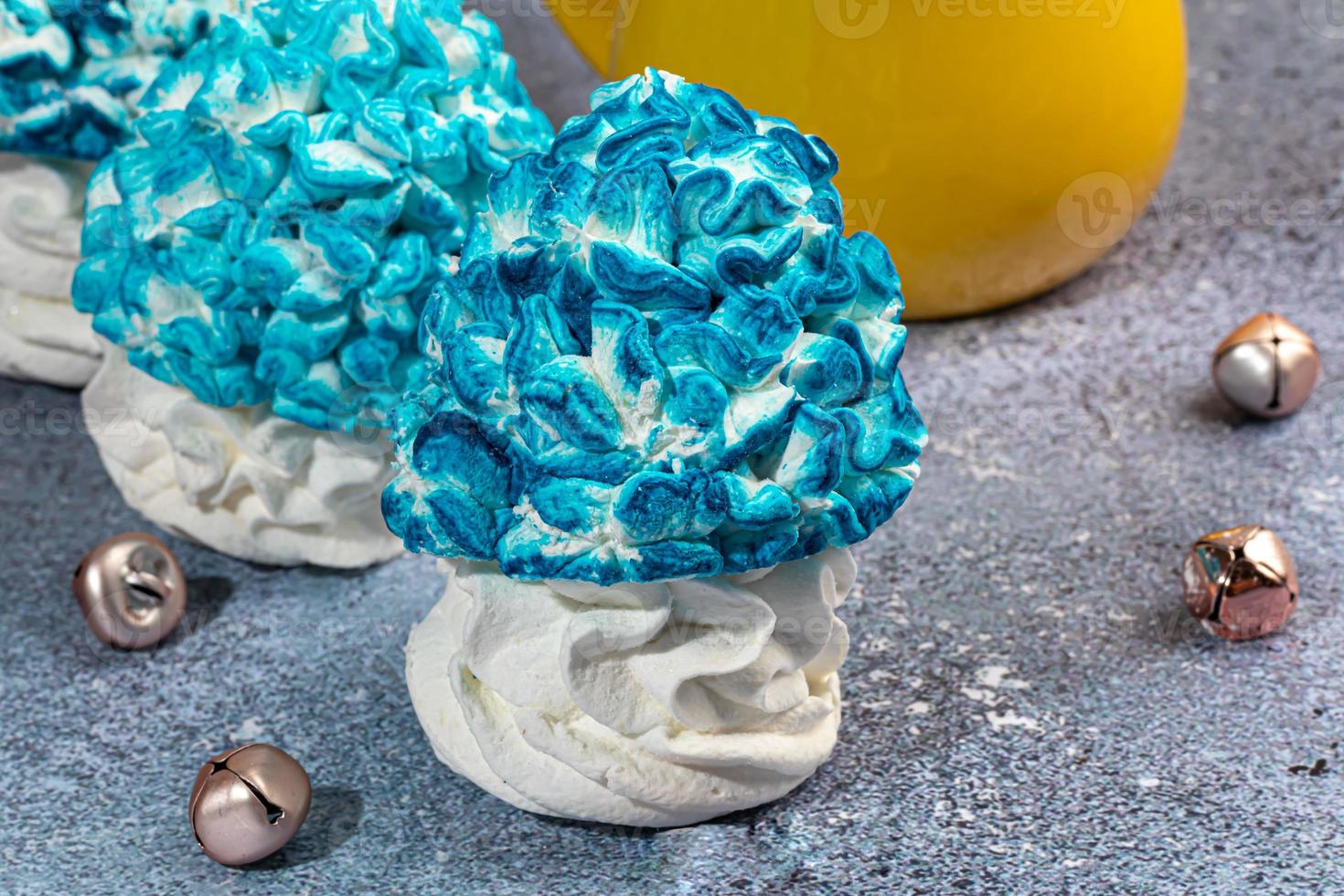 Handmade marshmallows on a light background in the form of roses, hydrangeas and tulips. There are flowers nearby. Women's day, Valentine's day. photo