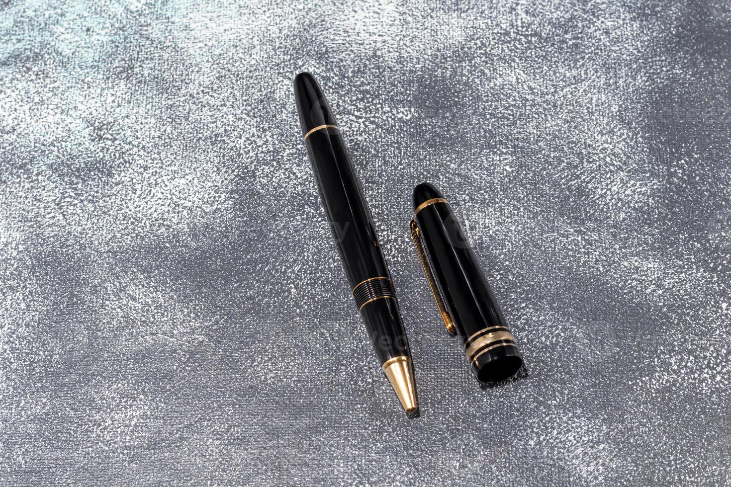 Fountain pen on a marble and gray background. Selective focus. photo