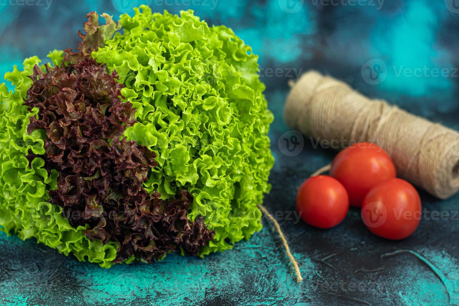 Leaves of green and red lettuce. Spring harvest, benefits and vitamins. On a dark background. photo