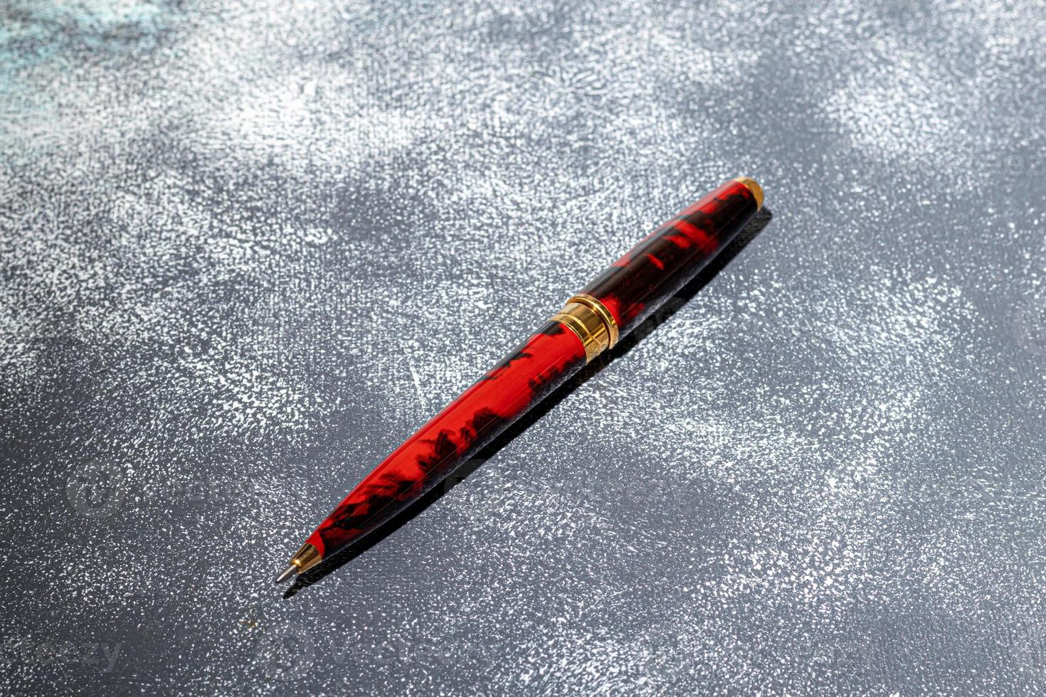 Fountain pen on a marble and gray background. Selective focus. photo