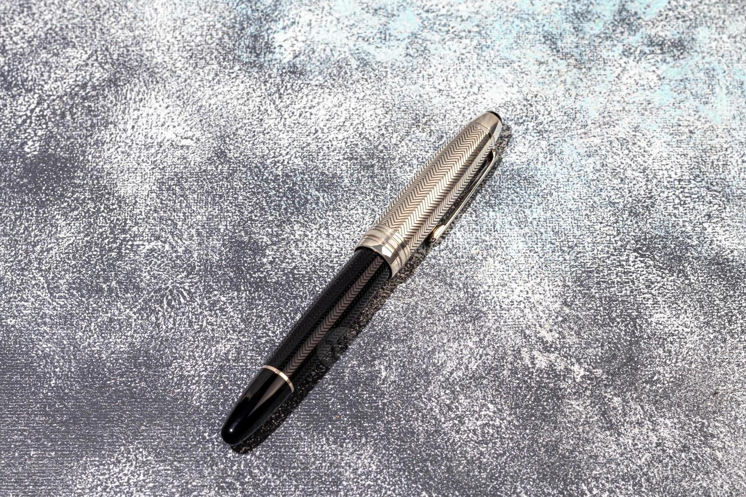 Fountain pen on a marble and gray background. Selective focus. photo