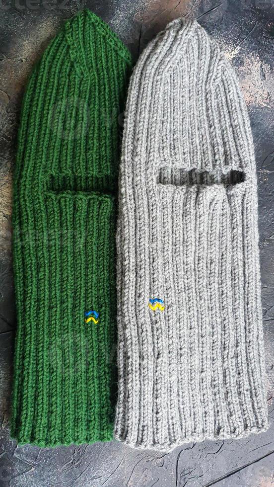 Handmade balaclava with Ukrainian symbols. Knitted from gray and green threads. Warms, reliably saves from the cold. photo