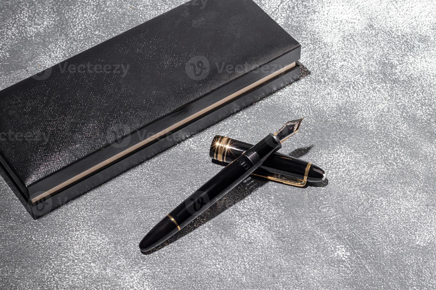 Fountain pen on a marble and gray background. Selective focus. photo