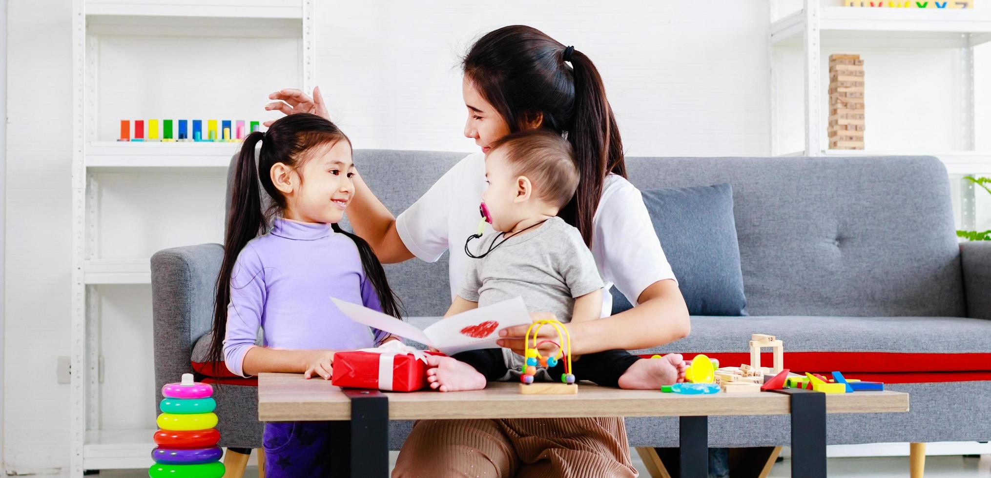 Happy single mom family, cute daughter sends love mom cards to mother and kiss photo