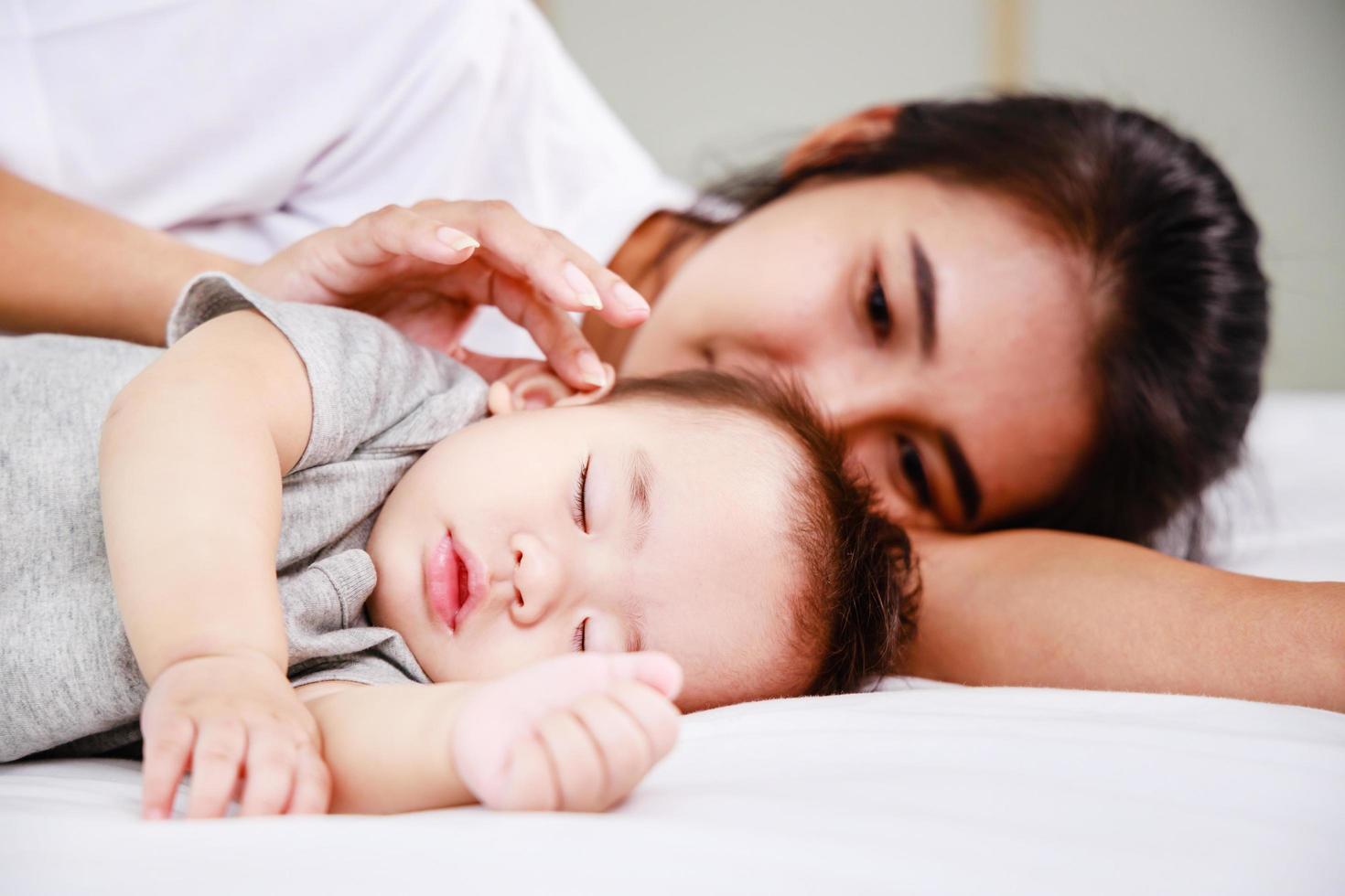 Close up of Mother holding hands her newborn baby. Happy kid, cute family. Mother love and fidelity. photo