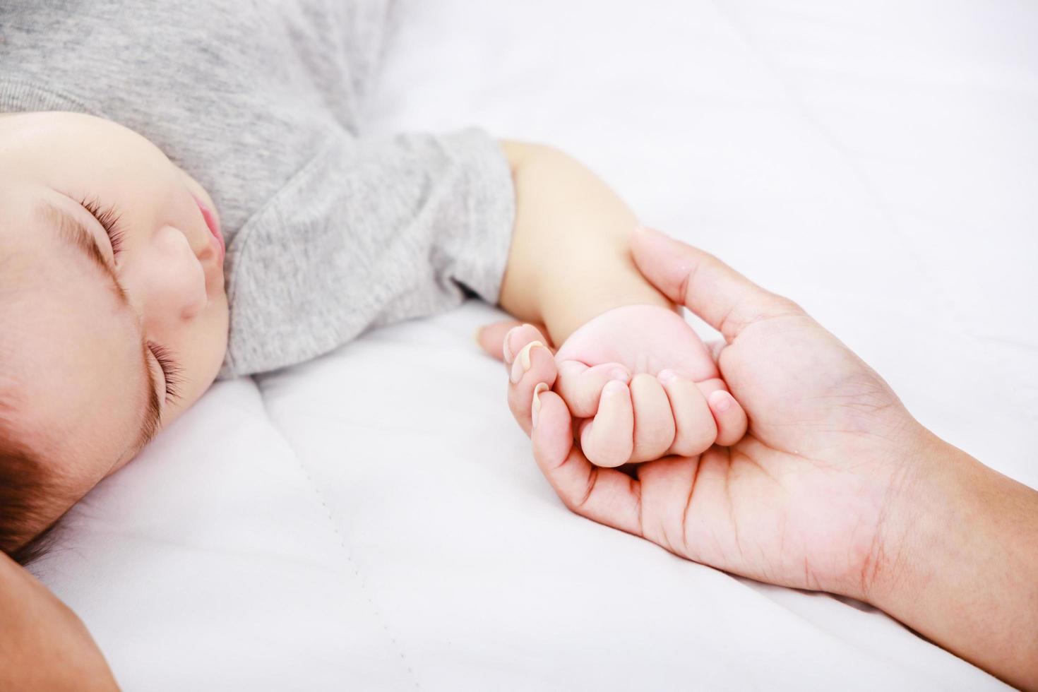 Happy family. Mom holds baby hand. Happy family newborn. photo