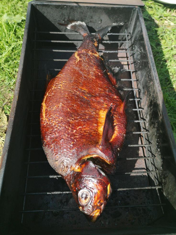 Smoked fish on the grill photo