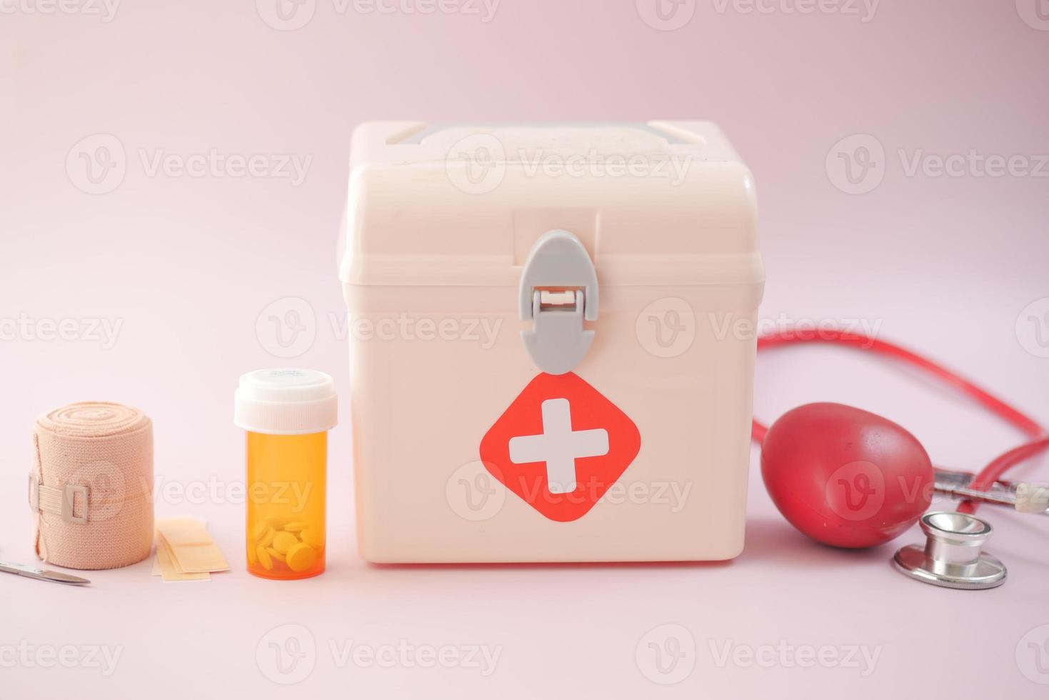 first aid kit box and medicine on table photo