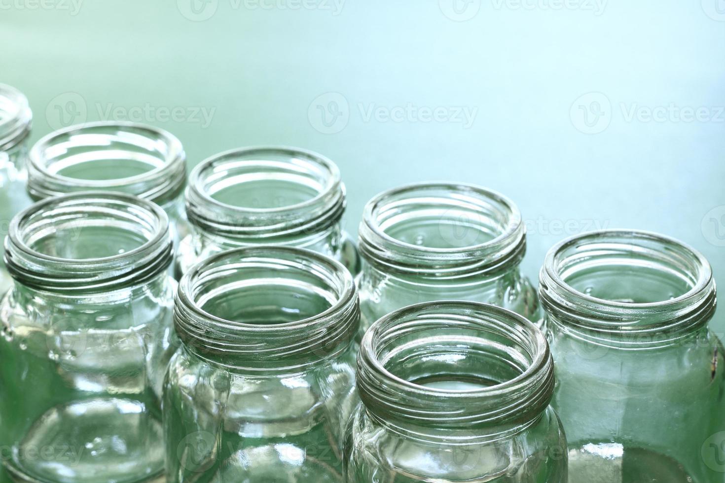 group of clear bottle with green background. photo