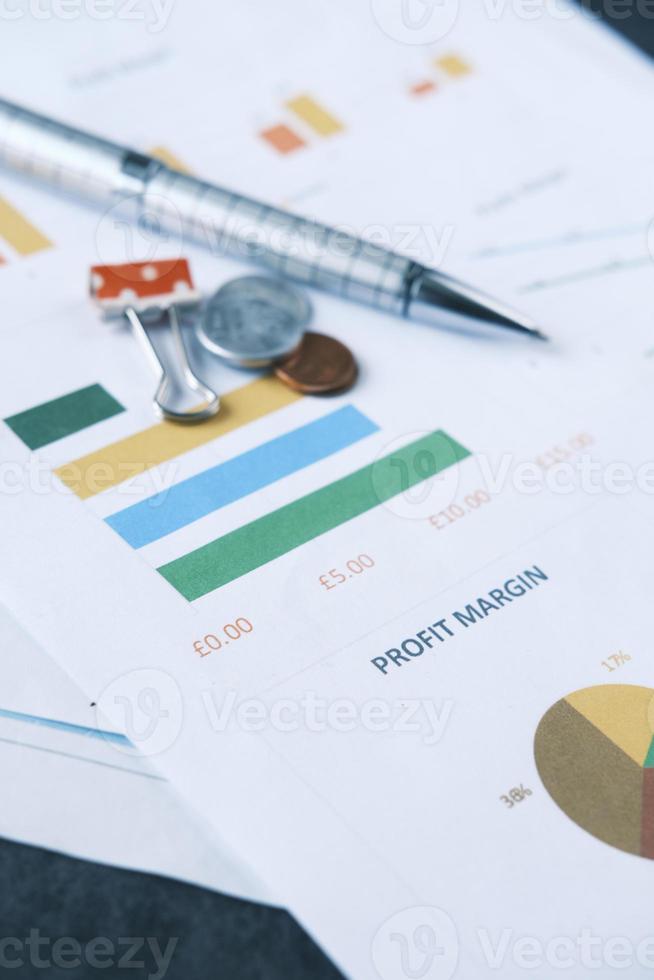 financial graph, calculator and notepad on table photo