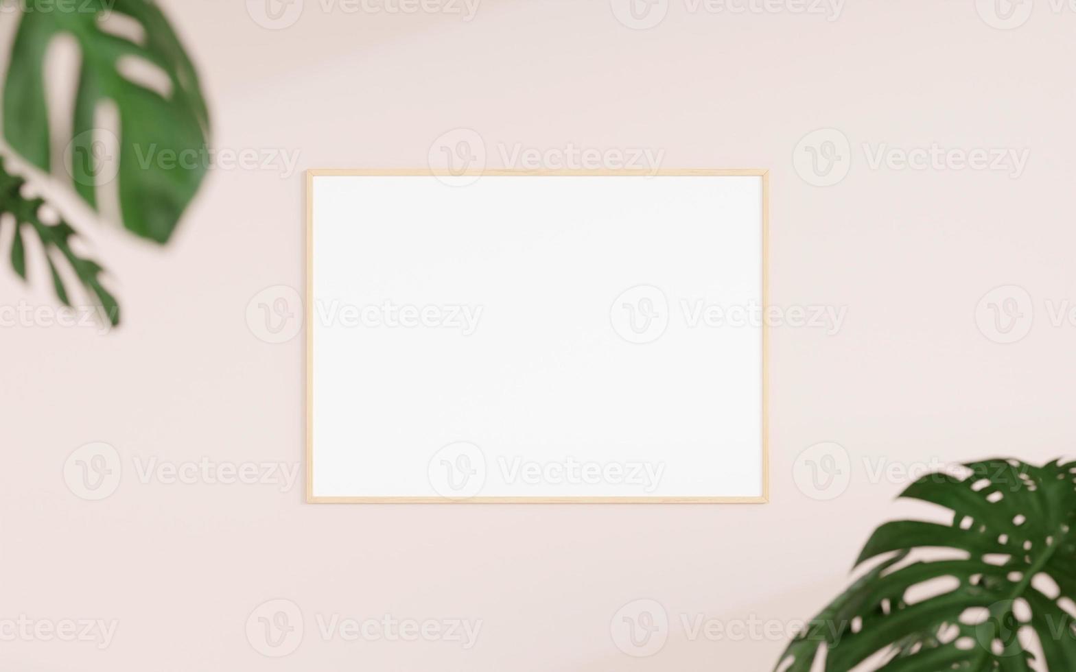 Clean and minimalist front view horizontal wooden photo or poster frame mockup hanging on the wall with blurry plant. 3d rendering.