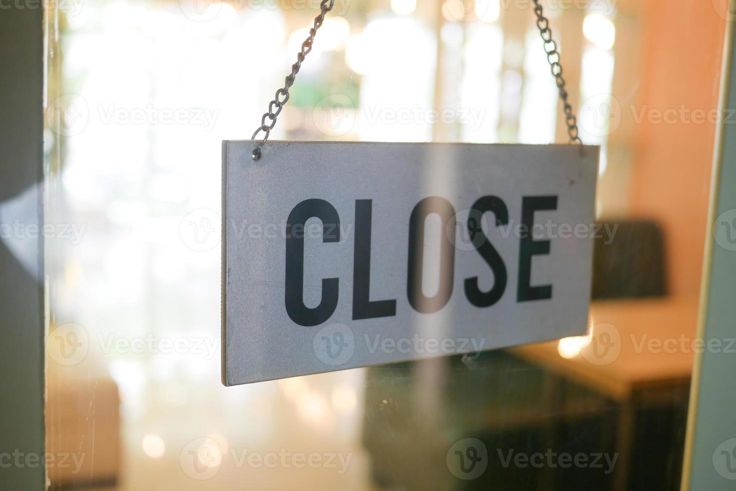 closed sign hanging on door of cafe. photo