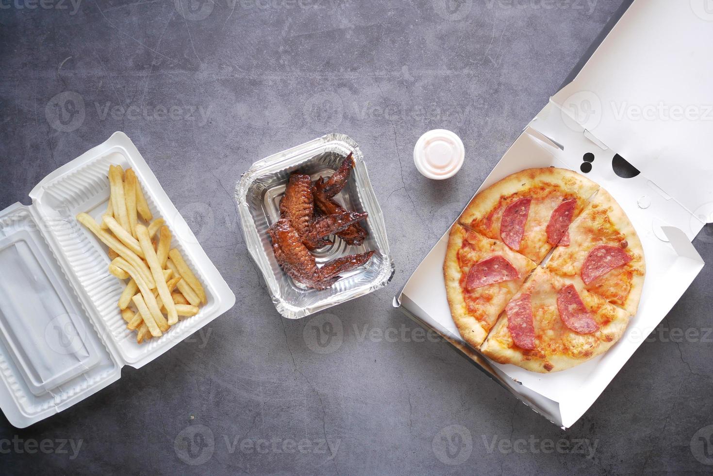 junk foods on a take away box on table photo