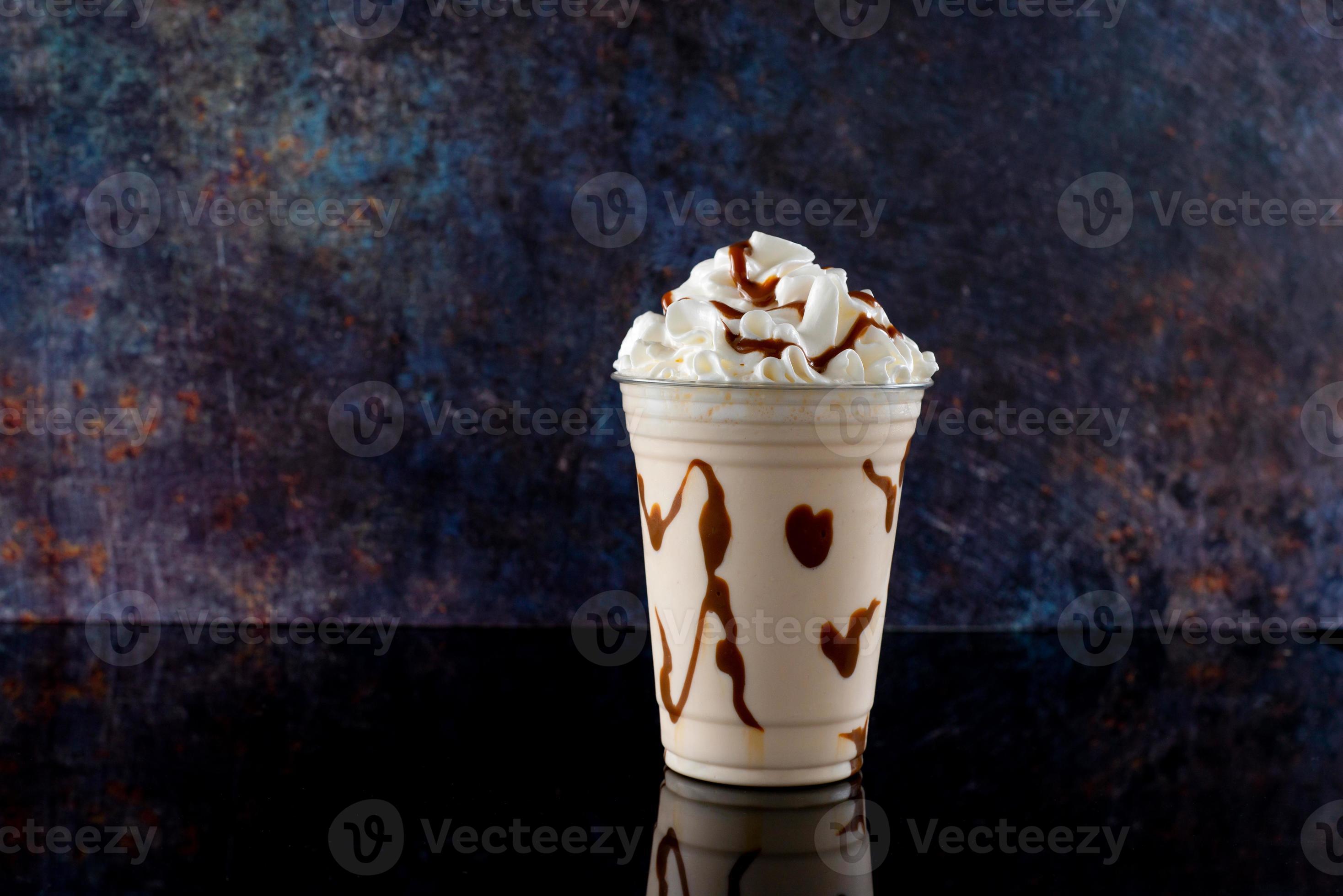 Vanilla Milkshake in Plastic Glass on a Dark Background. Vanilla