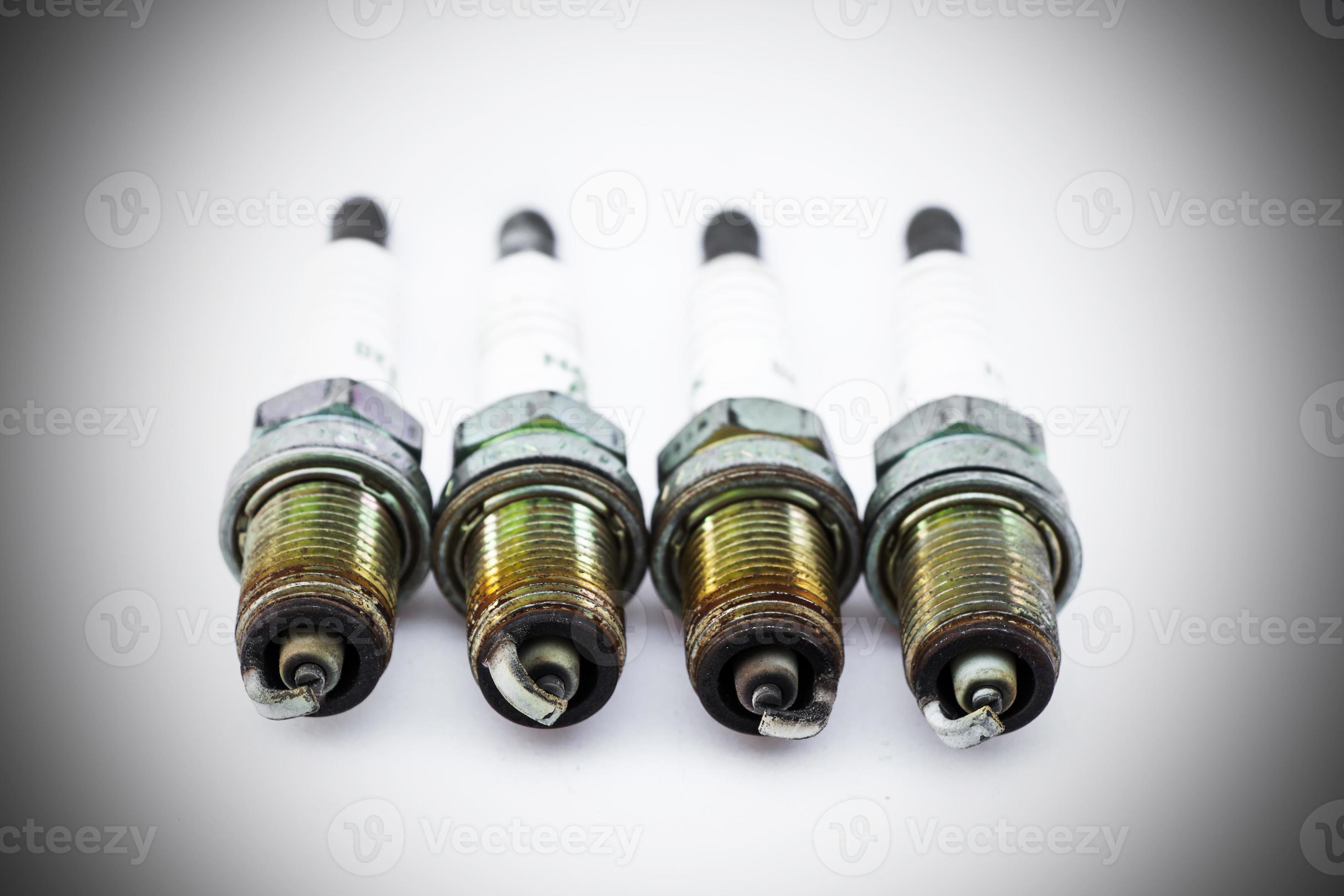 Four old burned spark plugs isolated on white background 9208397 Stock