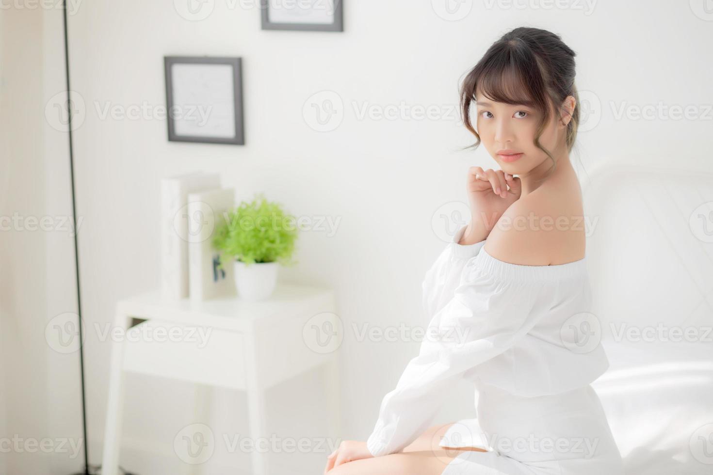 Portrait of beautiful young asian woman makeup of cosmetic, girl happy and smile attractive, face of beauty perfect with wellness in the bedroom at home with skin care and healthcare concept. photo