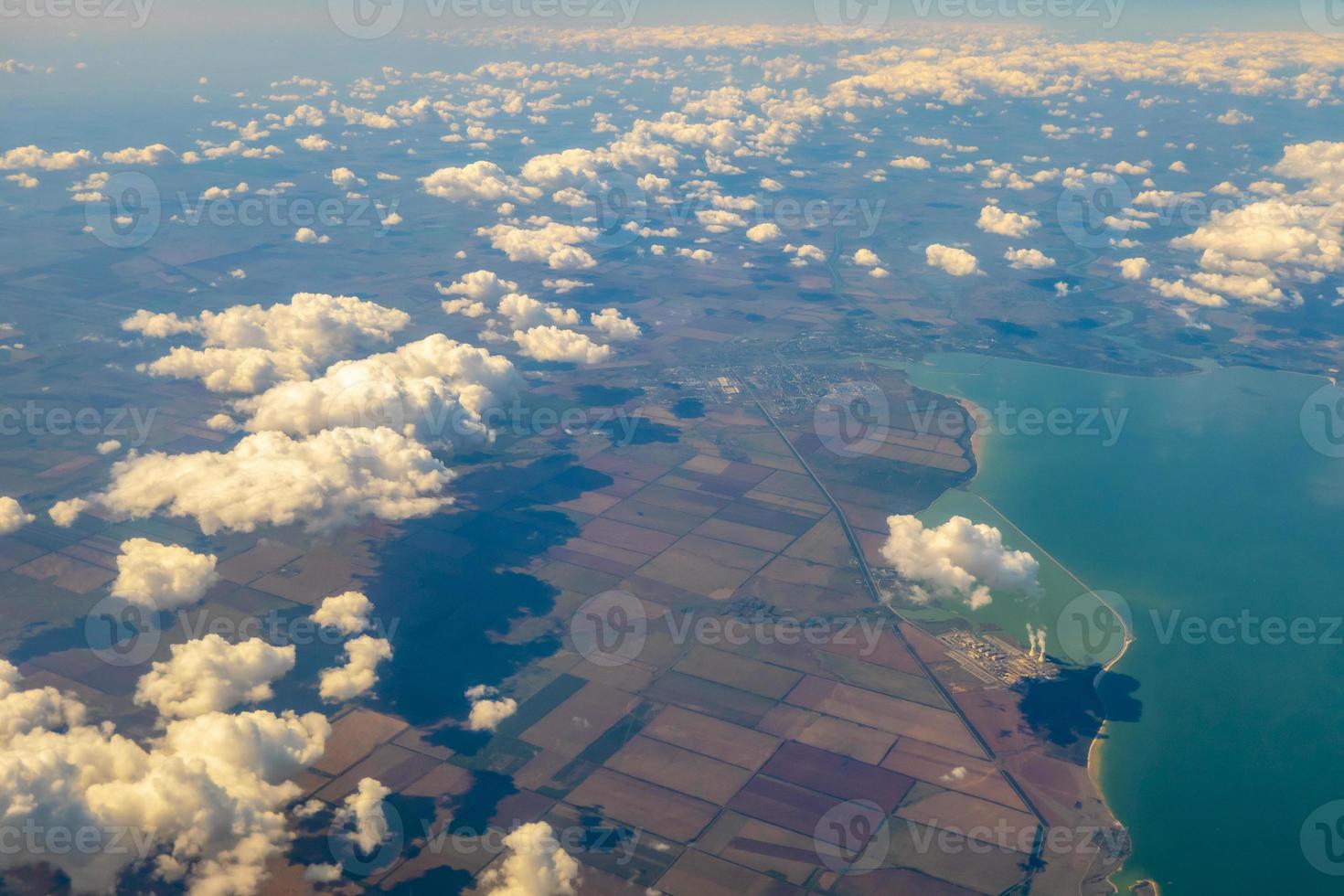 Aerial photo of Farmland. view from the plane to the ground. squares of fields under the clouds