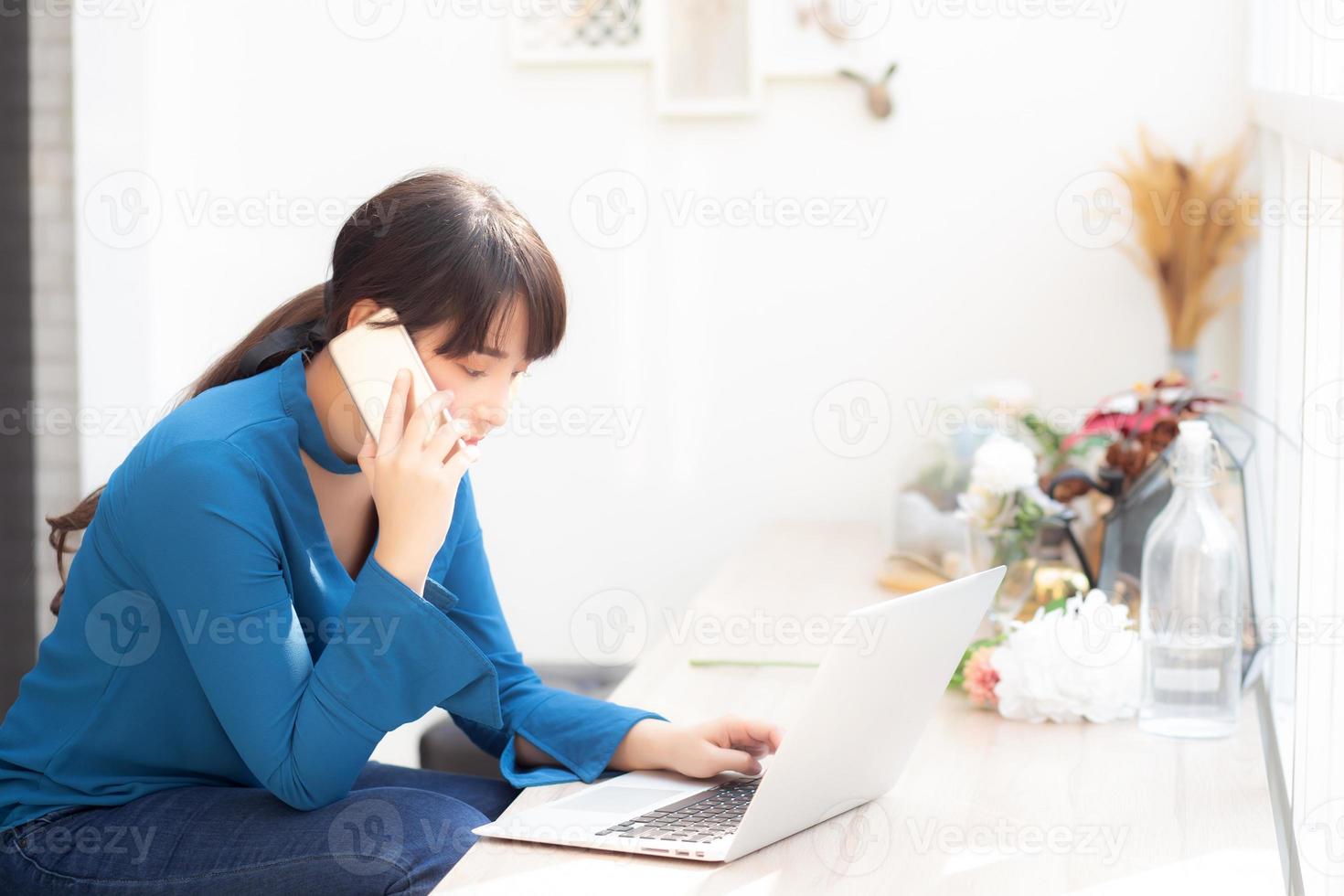 Beautiful asian young businesswoman excited and glad of success work with laptop, girl taking mobile smart phone and working coffee shop, career freelance business concept. photo