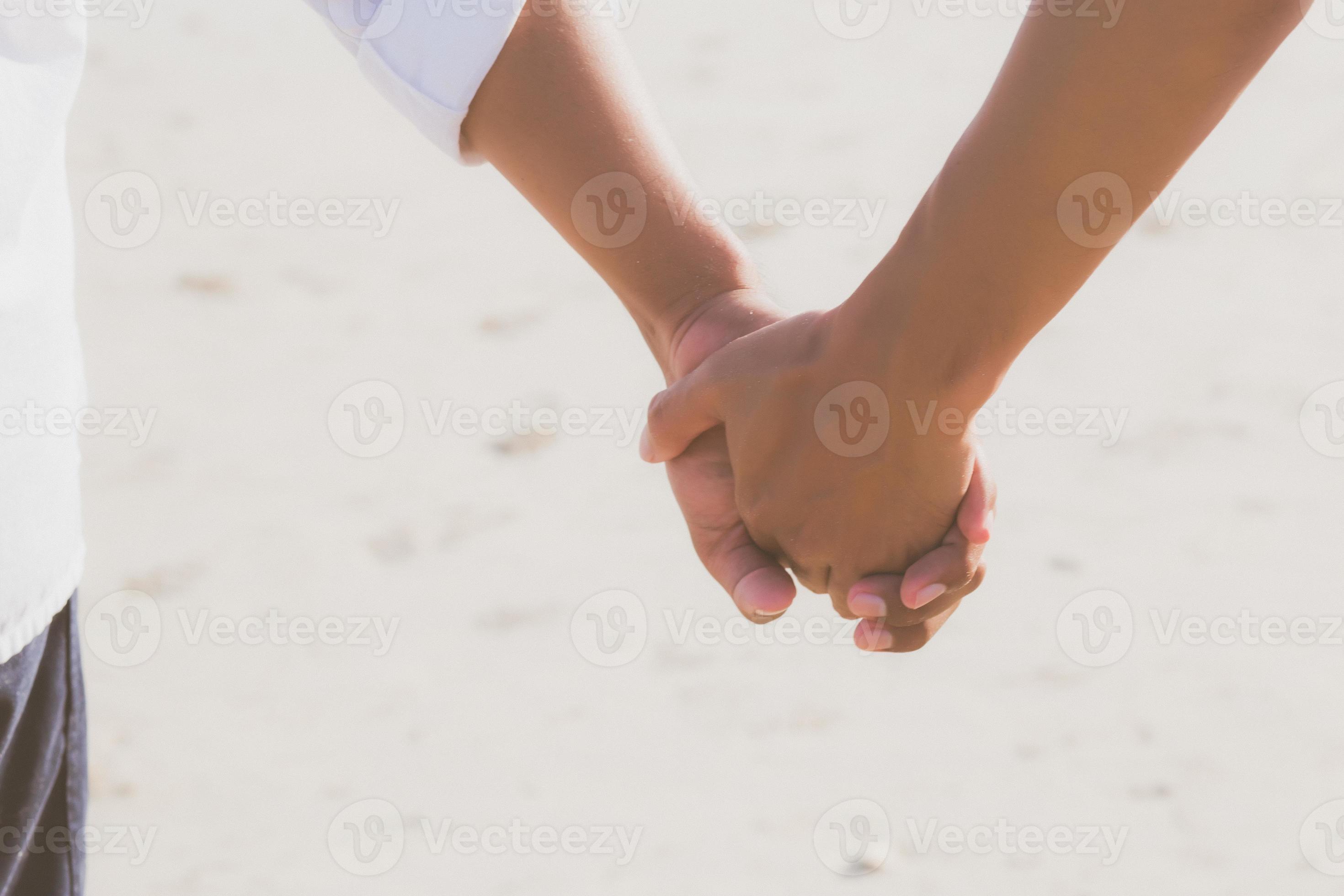 Closeup asian gay couple holding hands together on the beach with relax and leisure in summer, LGBT homosexual legal two man happy and romantic in vacation, relationship sex lover concept