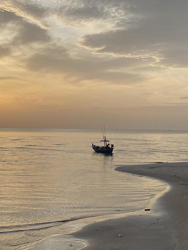 Boat on sunset beach photo