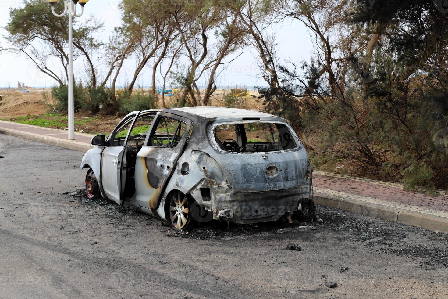 Burnt out car on the road photo