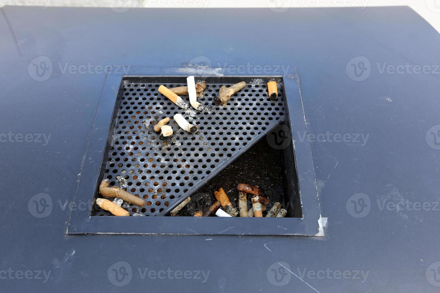 Ashtray - a container for tobacco ash, cigarette butts, cigars. photo